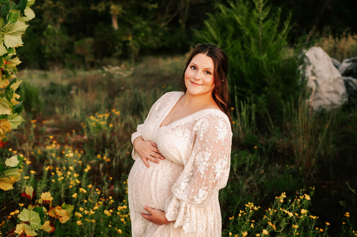 pregnant mom in lace smiling during Springfield MO maternity photography session