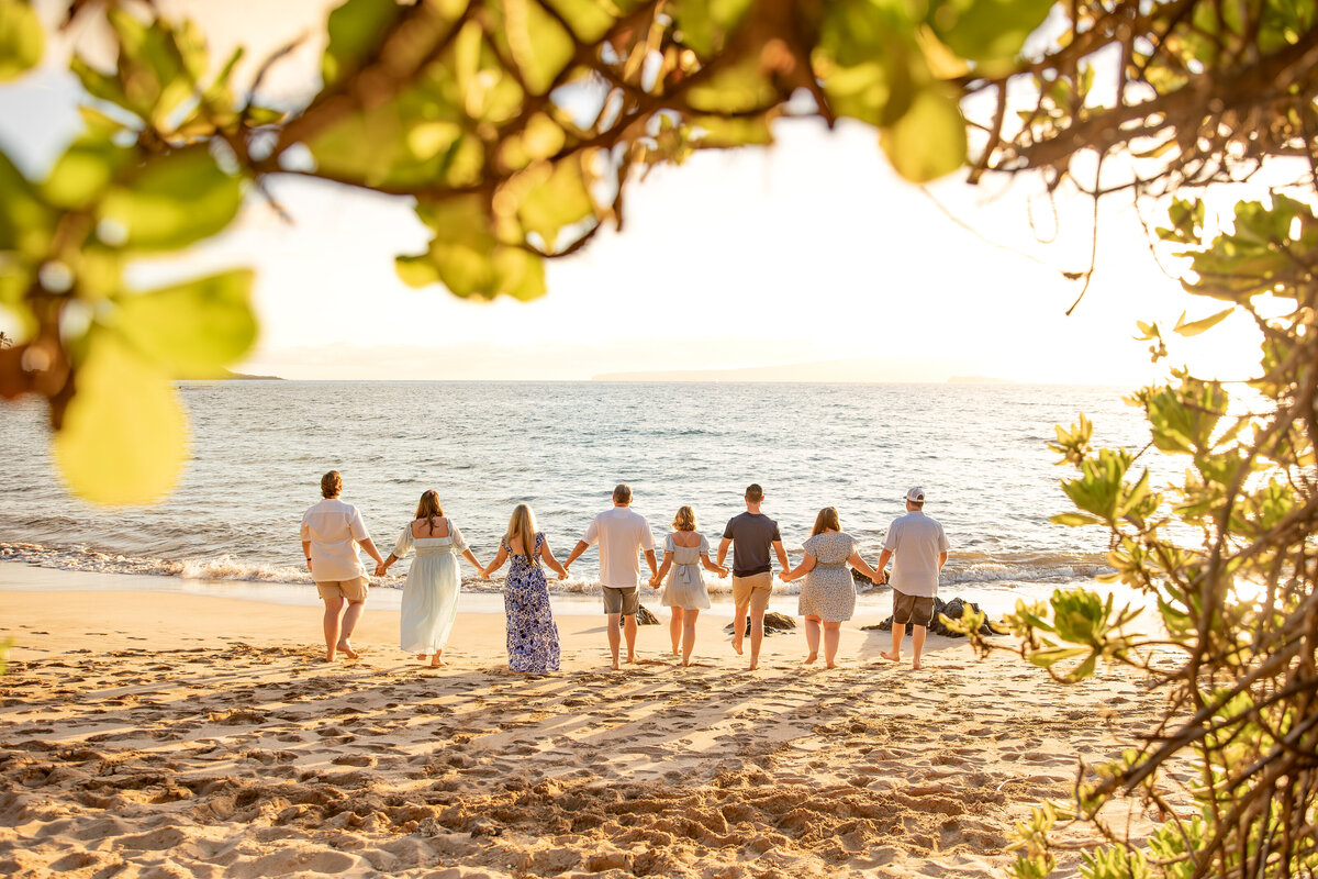 Maui Family Photographers capture family walking together on beach during family photos
