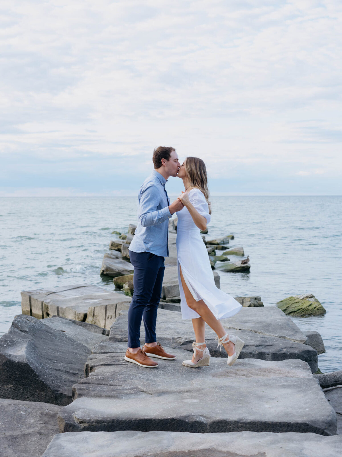 Outdoor engagement session with scenic lake views on a Cleveland beach.