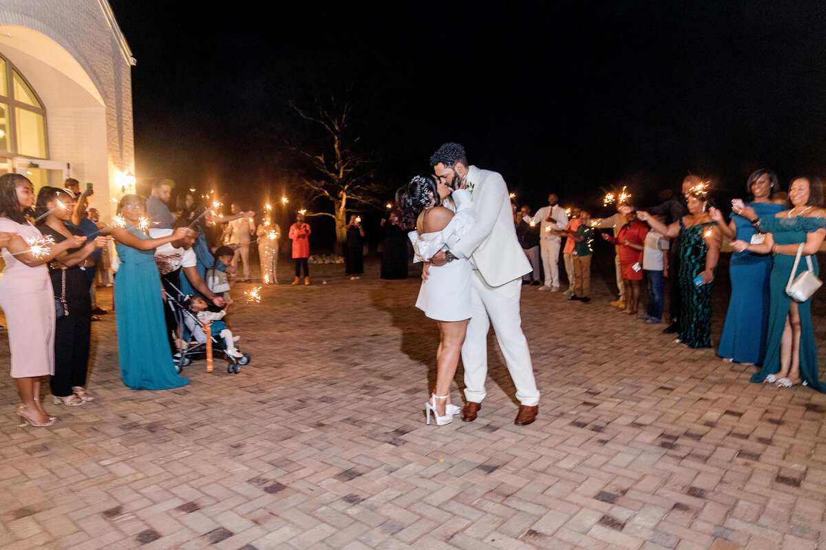The newlyweds embrace for a final dance, surrounded by twinkling lights and loved ones.