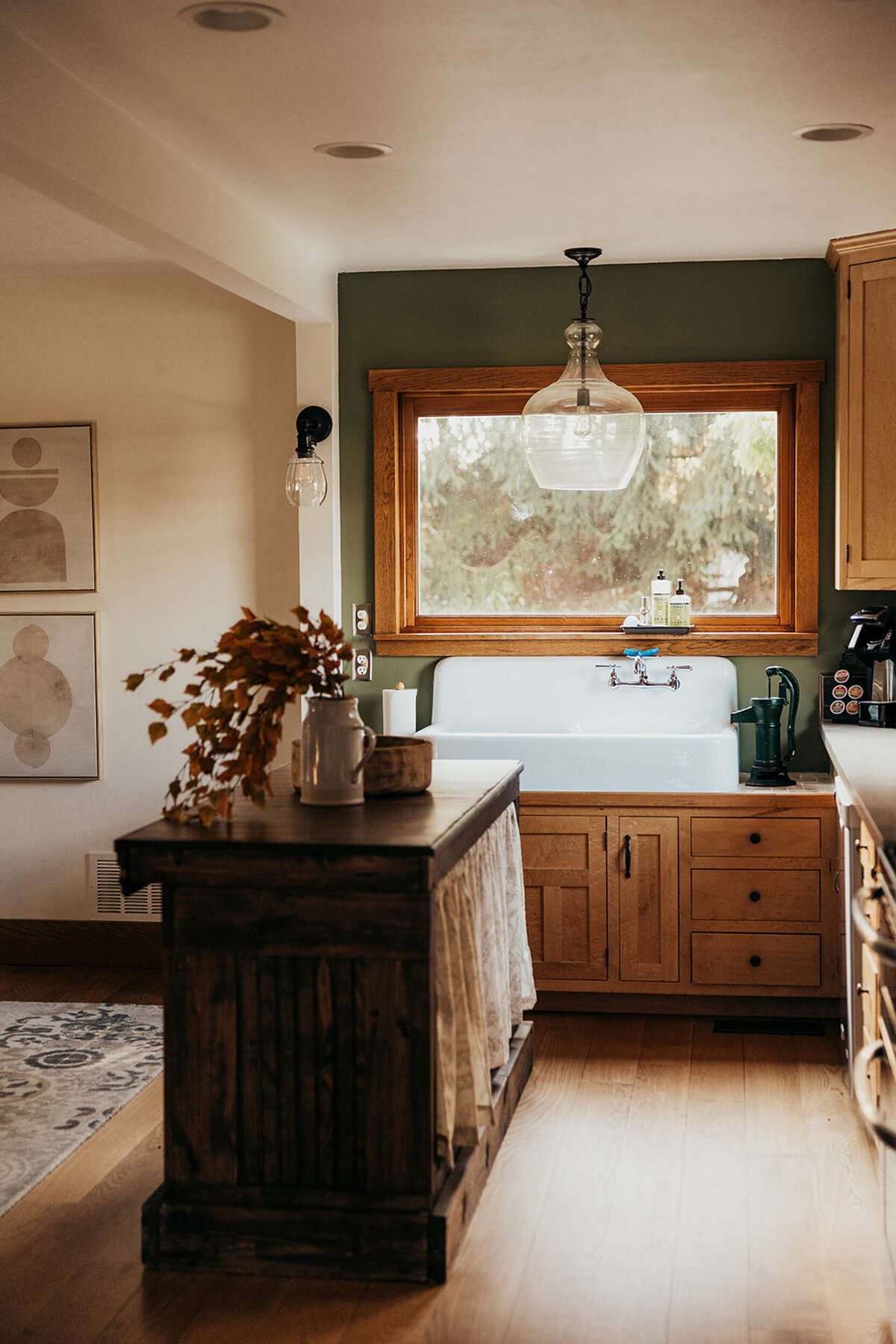 an antique kitchen island and vintage drainboard sink in the kitchen of the modern farmhouse overnight accommoadations at Willowbrook wedding venue