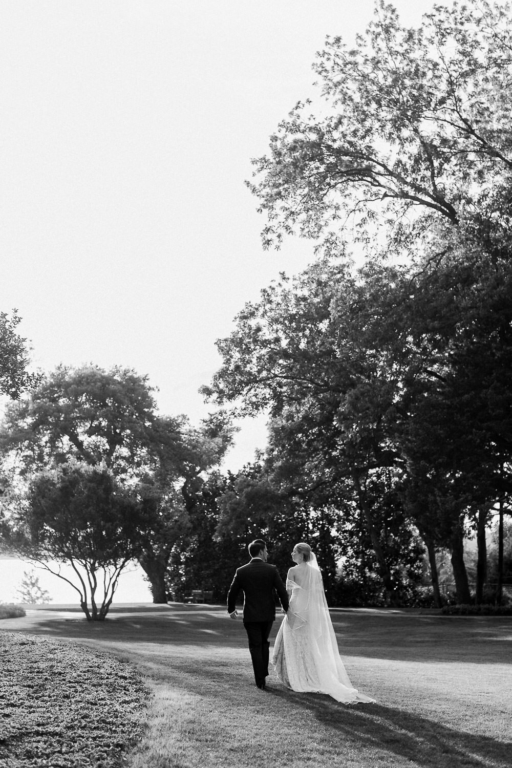 Bride and groom recessional Dallas white rock lake Arboretum wedding sunset
