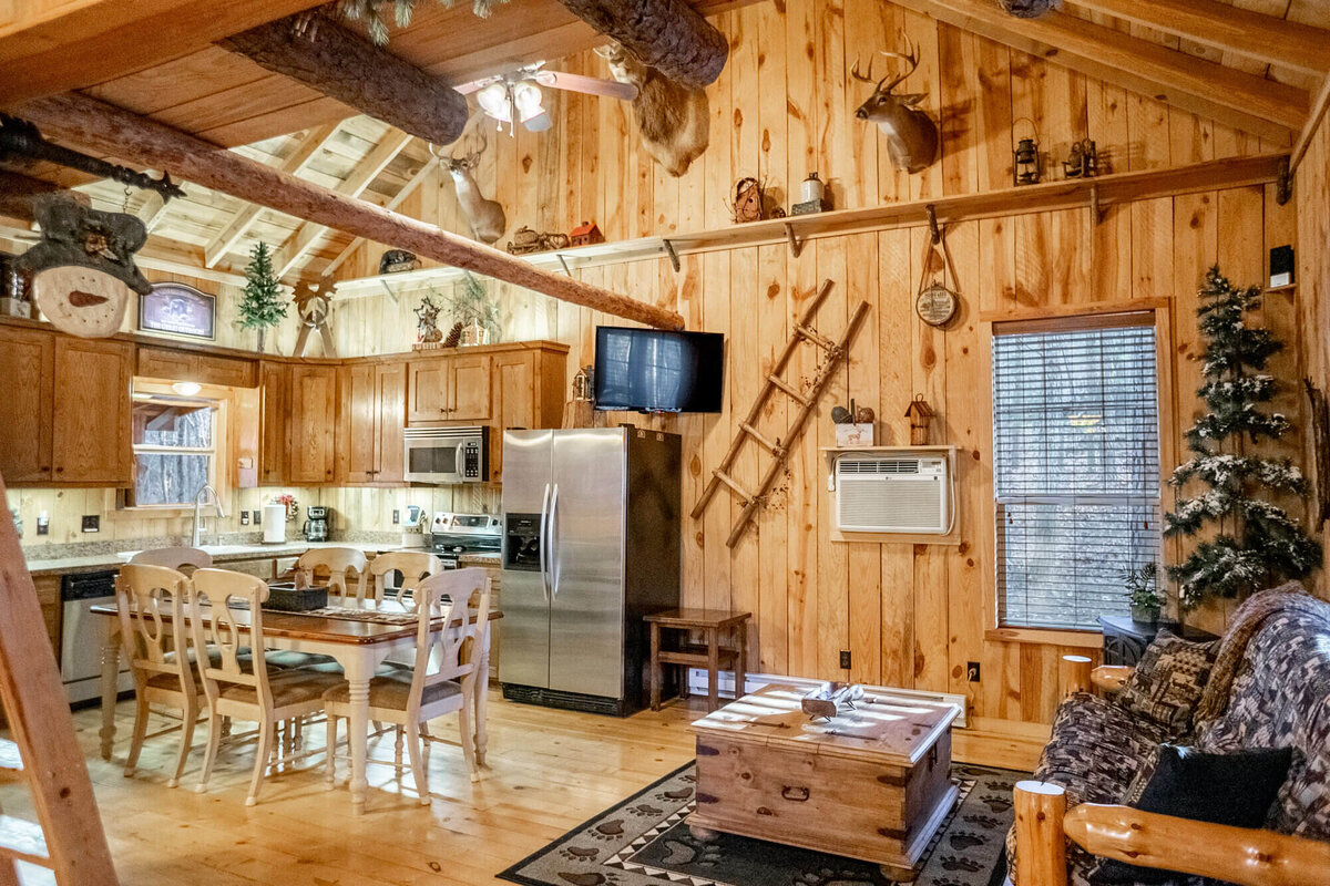 Spacious living and dining area inside charming cabin near ATV trails