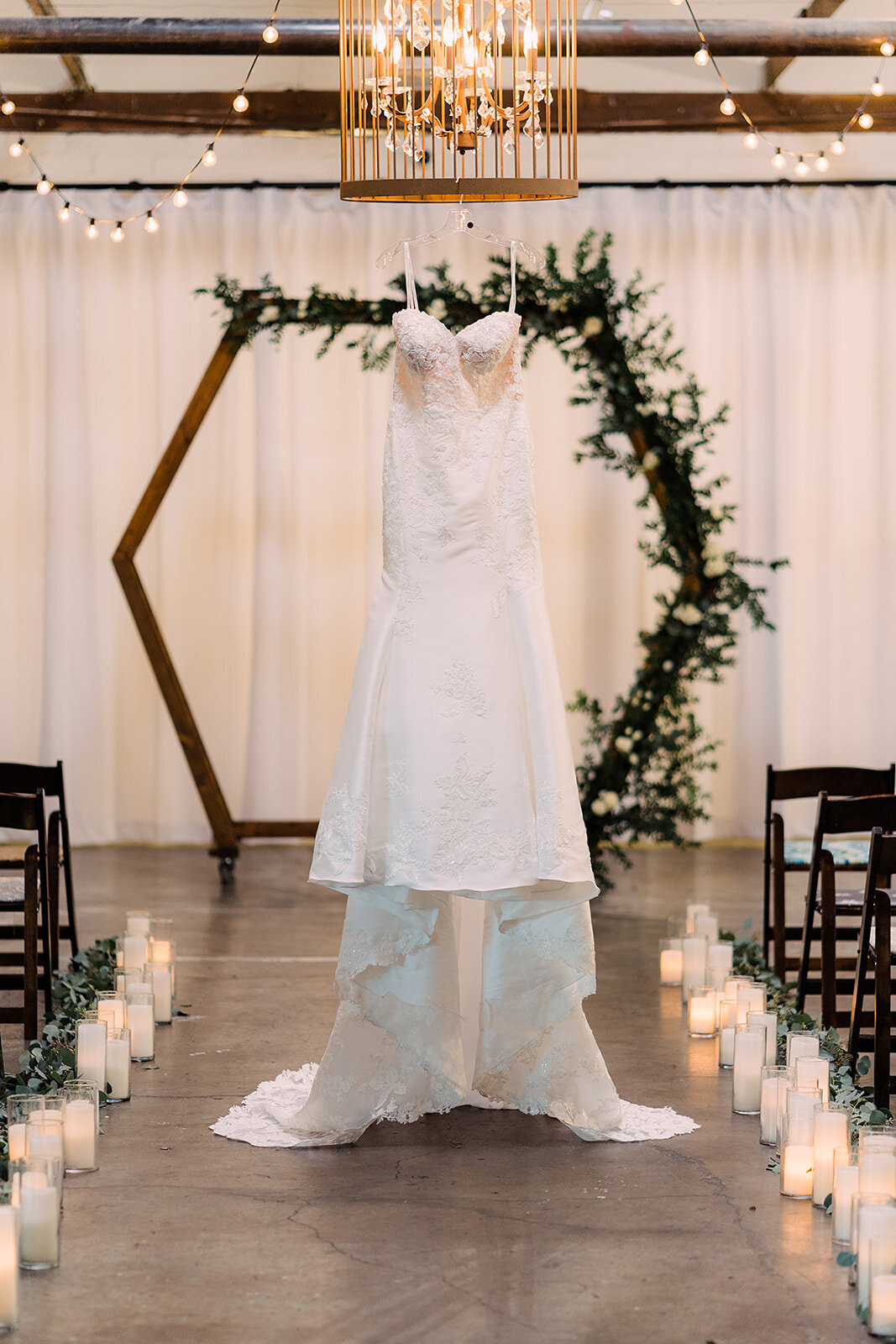 A dress hangs from a chandelier