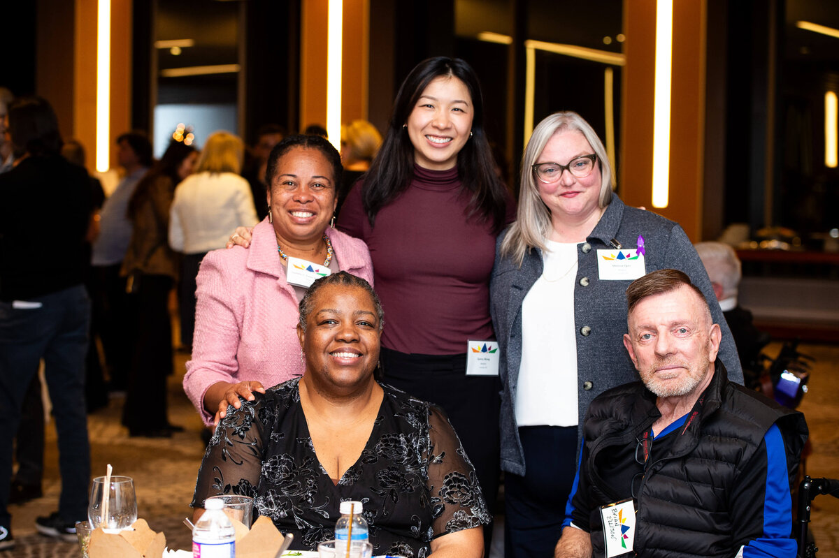 a table shot of smiling attendees during a corporate event.  Captured by Ottawa Event Photographer JEMMAN Photography COMMERCIAL