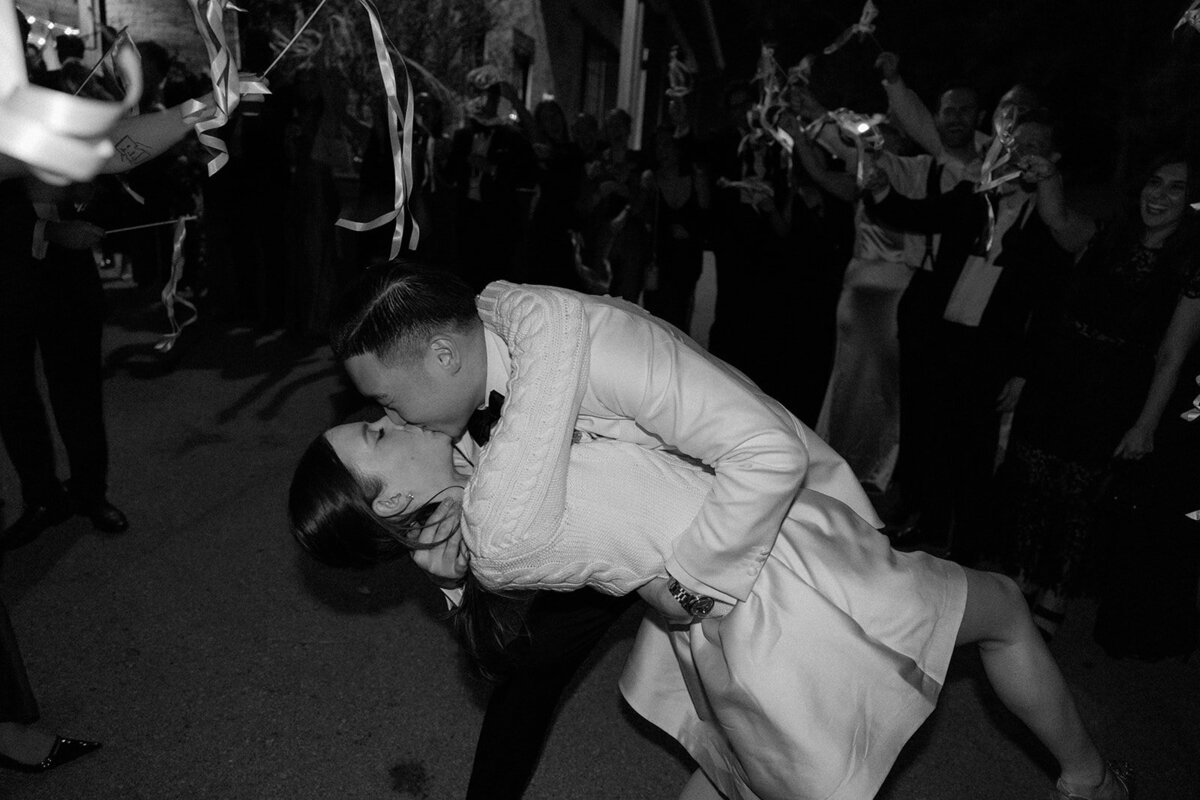 Romantic street portraits of bride and groom under moody nighttime city lights during sendoff.