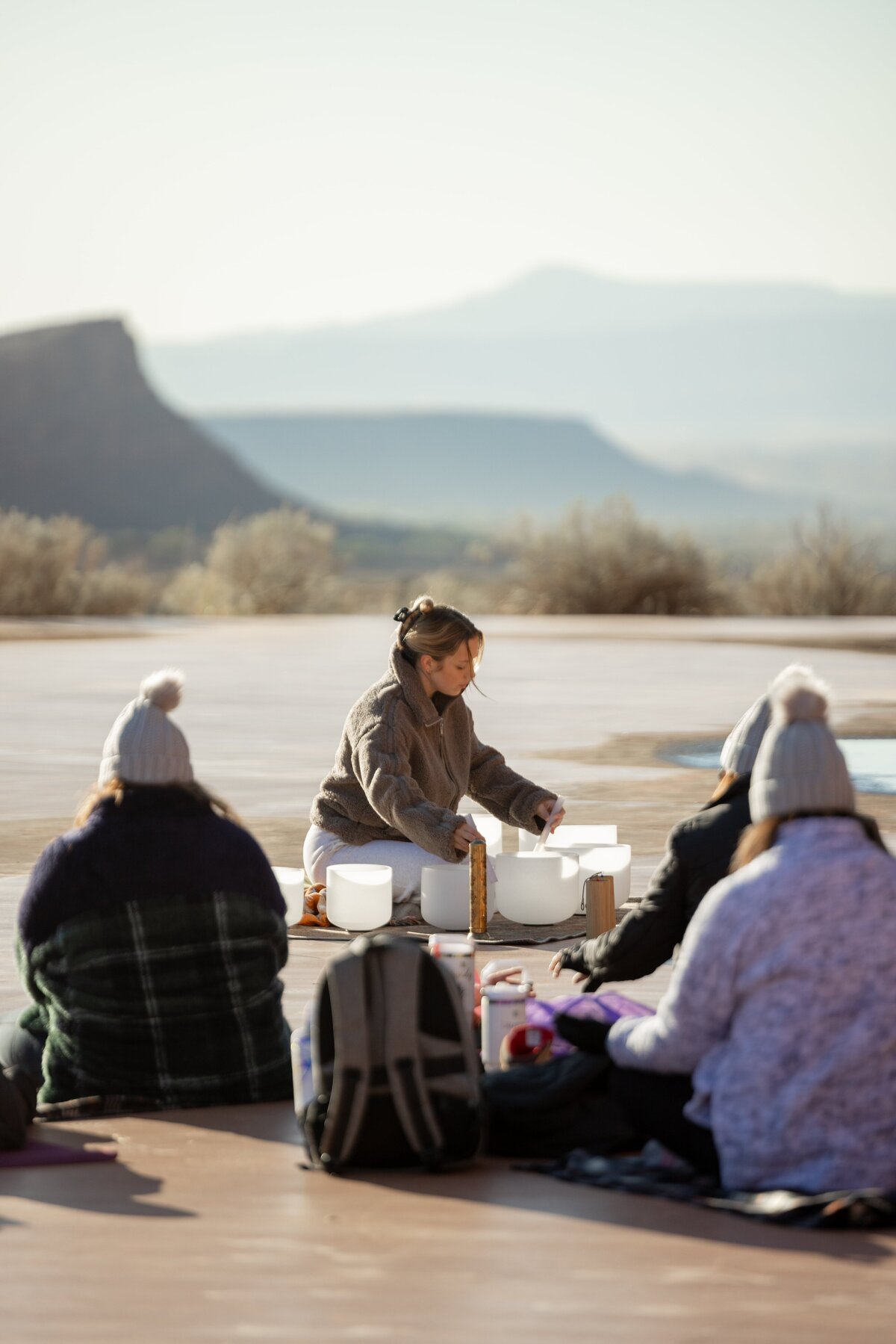 woman doing a sound bowl session with group