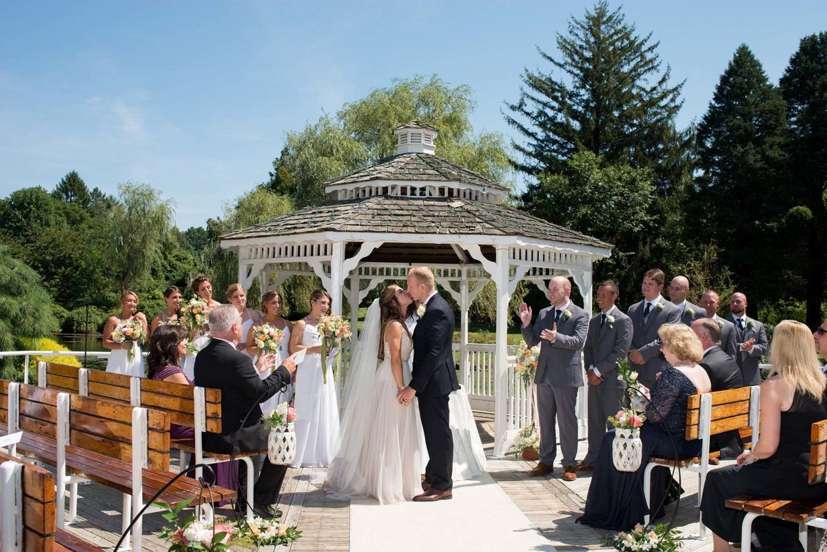Bride and groom kissing at the alter at Flowerfield