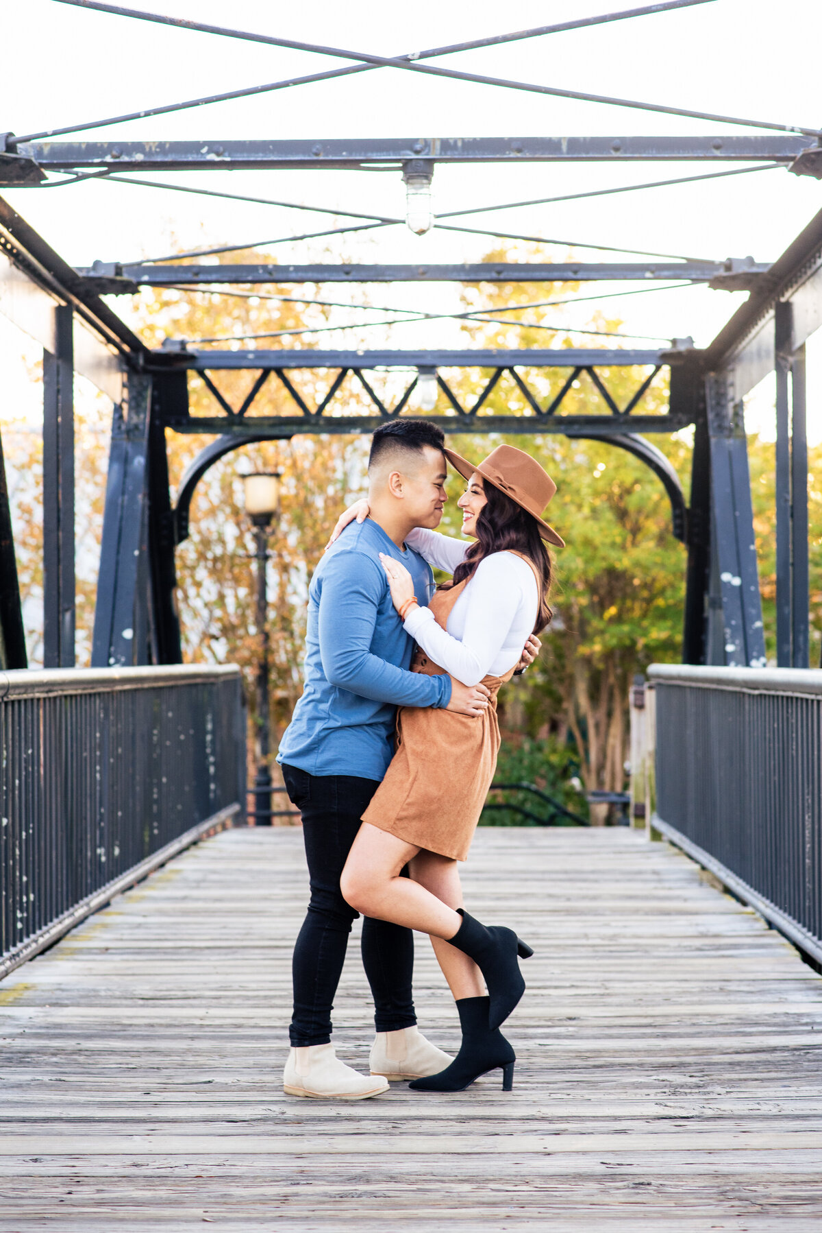 Man-gently-dipping-his-fiance-on-the-bridge-at-Riverfront-Park-in-Columbia-SC-as-part-of-their-engagement-session