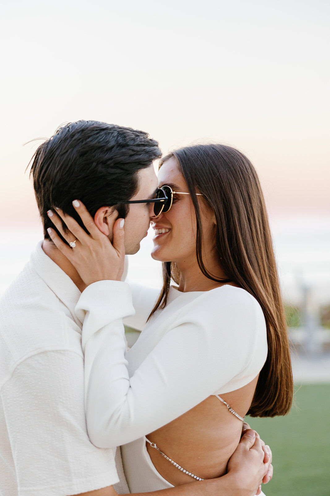 Rebecca places her hands on Graysen’s face as they lock eyes, sharing a tender and romantic moment during their engagement session at the luxurious Marriott Hotel Fort Lauderdale.