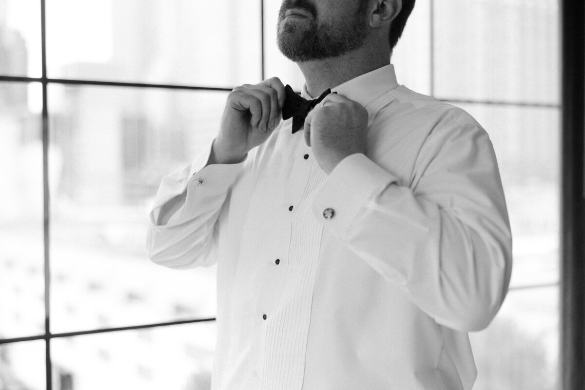 groom-getting-ready-bow-tie-black-and-white