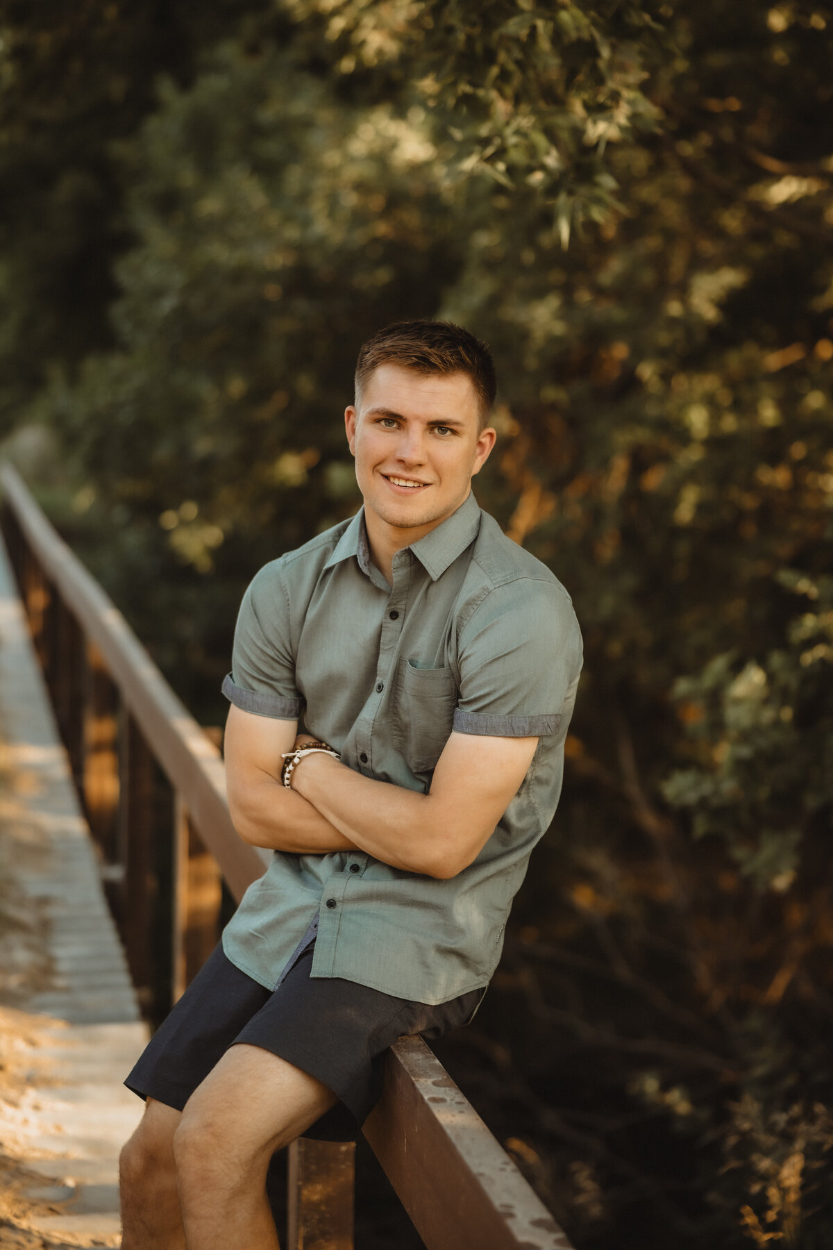 SENIOR GUY SITTING ON BRIDGE