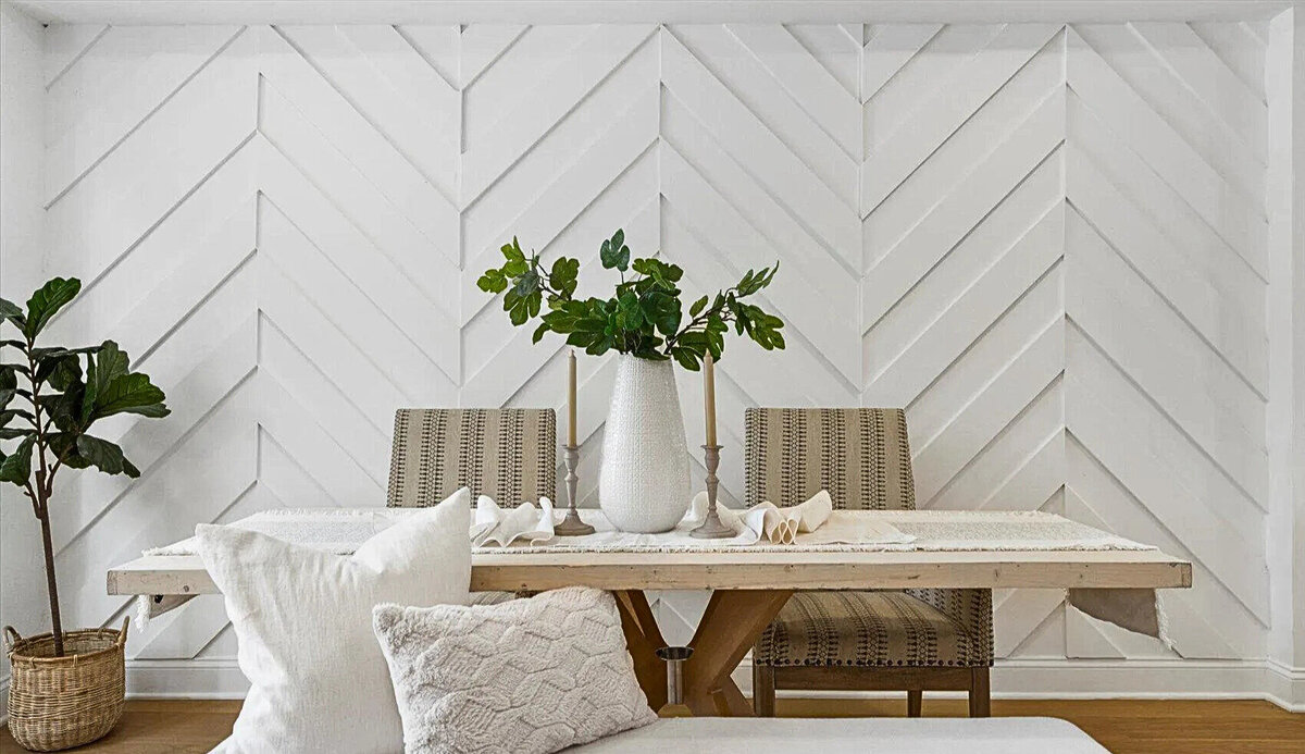 Custom dining space featuring a chevron accent wall, natural wood table, and modern finishes—designed to bring style and character to everyday living.