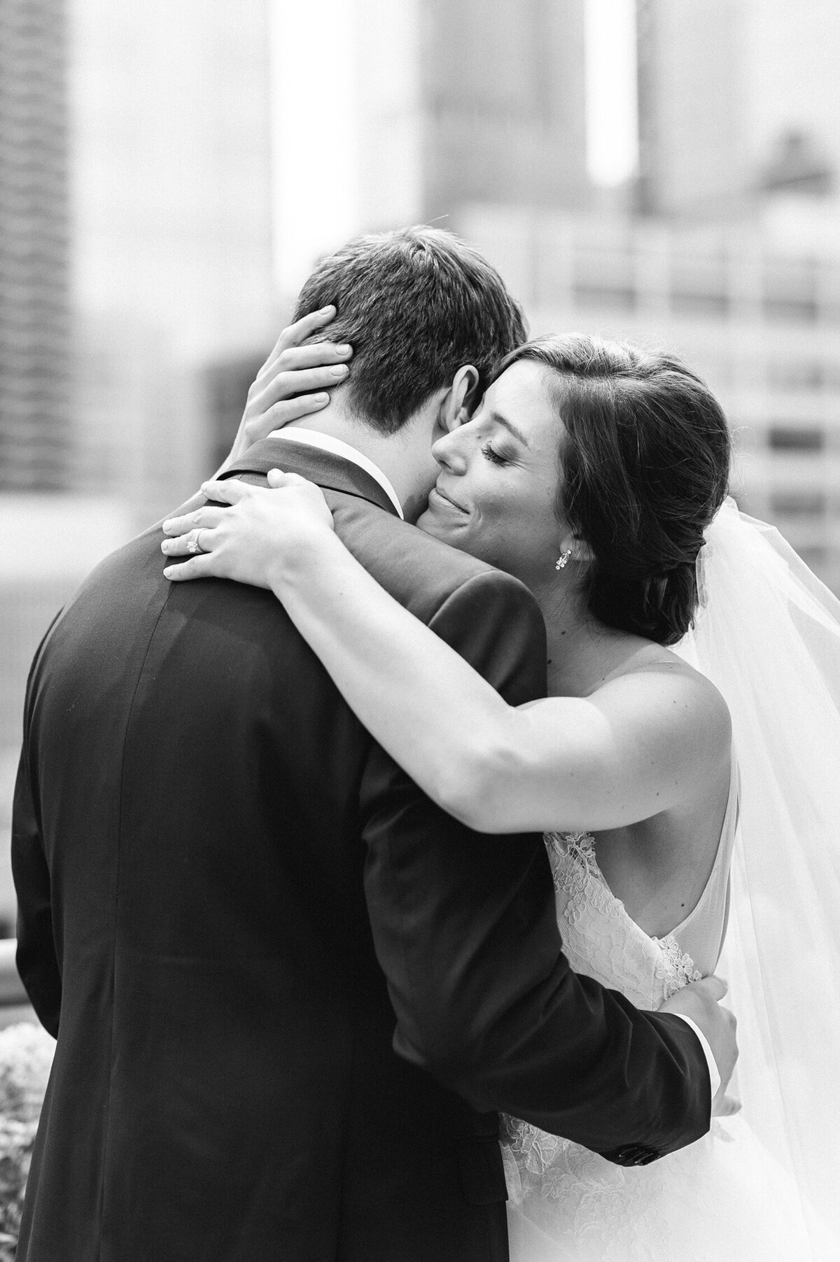 Bride embracing the groom with a city backdrop