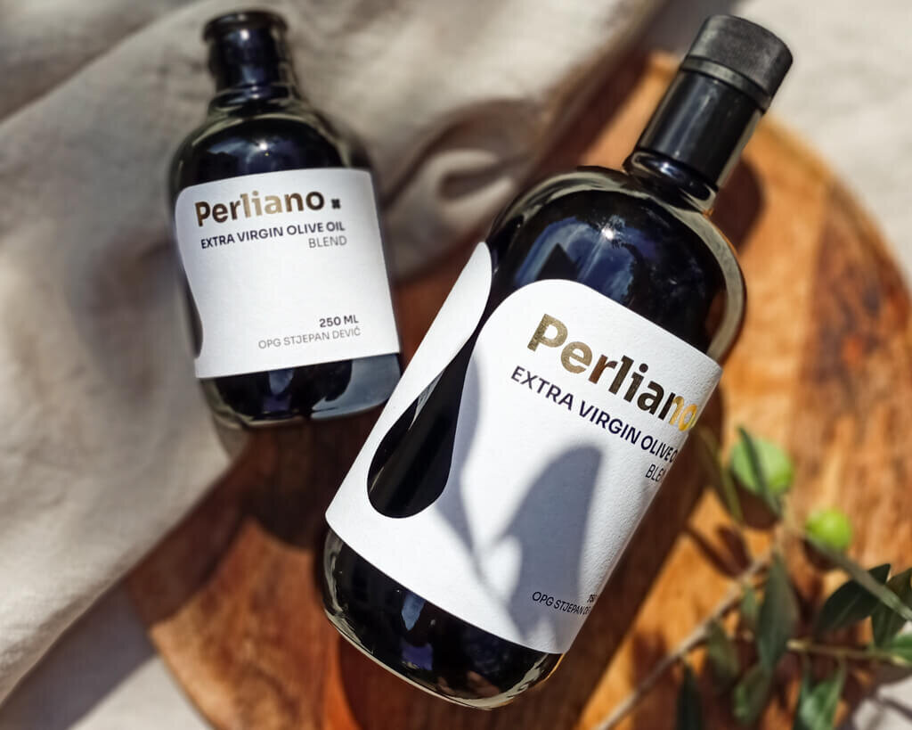 remium extra virgin olive oile labels and packaging on a linen cloth with olive branches by Studio Stoked