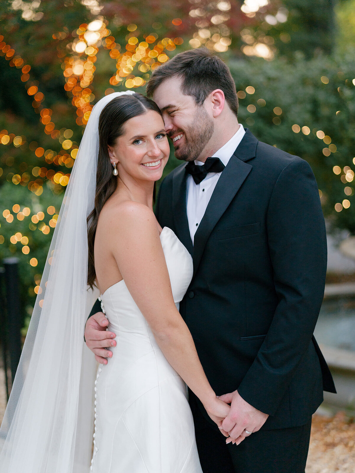 bride and groom hugging and holding hand