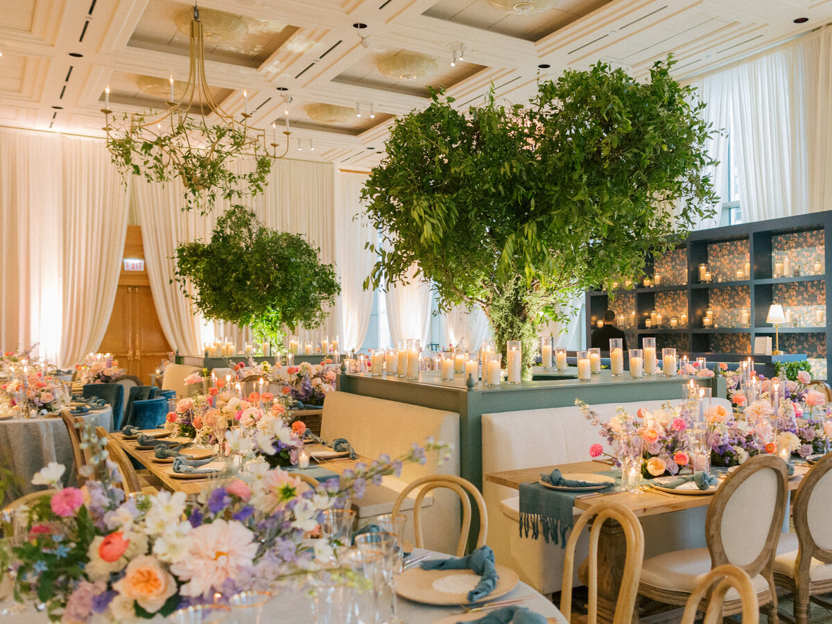 A luxurious wedding reception at The Peninsula Chicago, featuring a colorful floral design and elegant table settings.