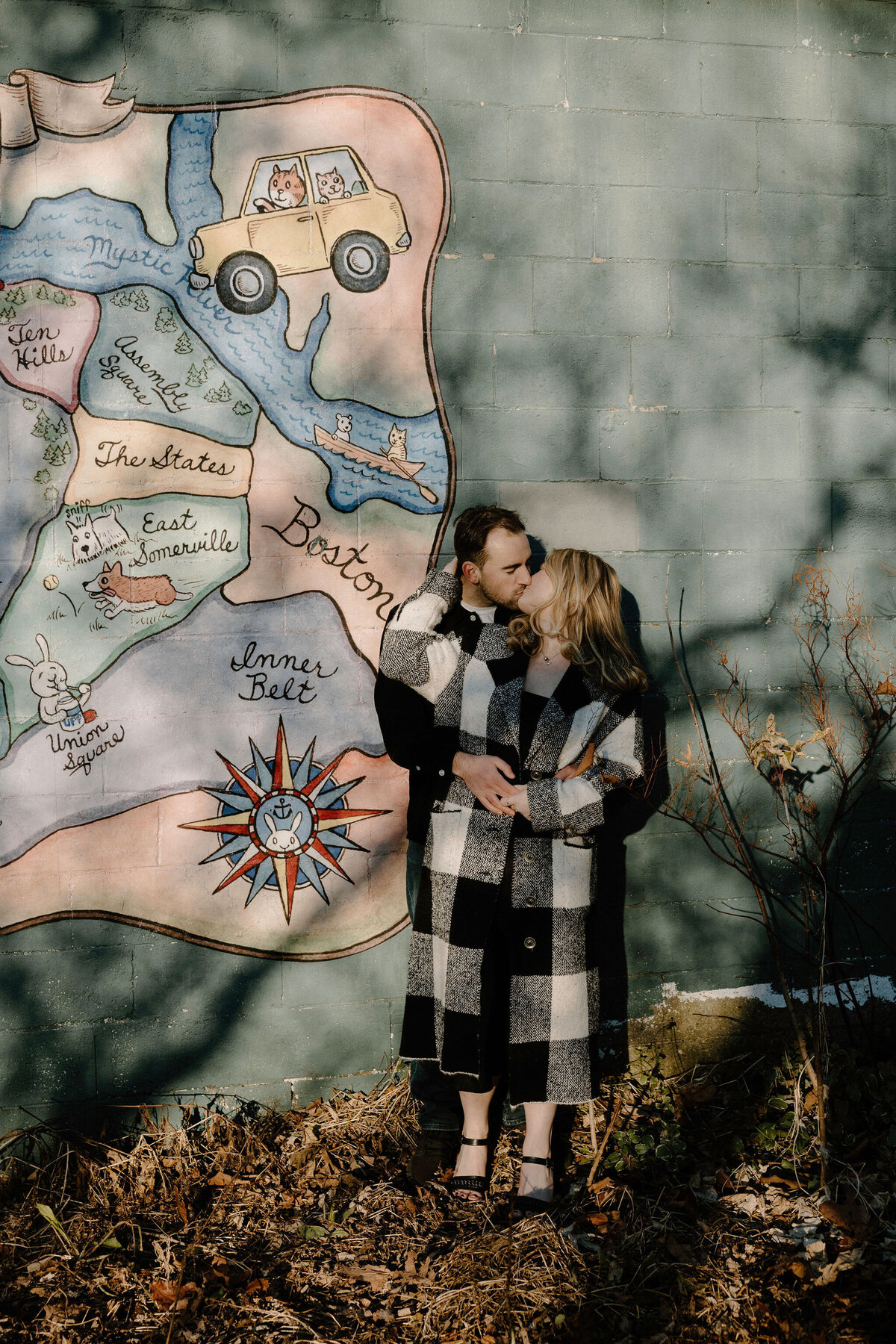 engaged couple kissing in somerville ma