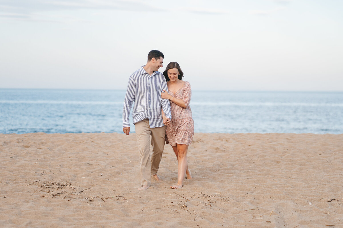 Natural and timeless engagement photos at the beach, capturing genuine moments by the ocean.