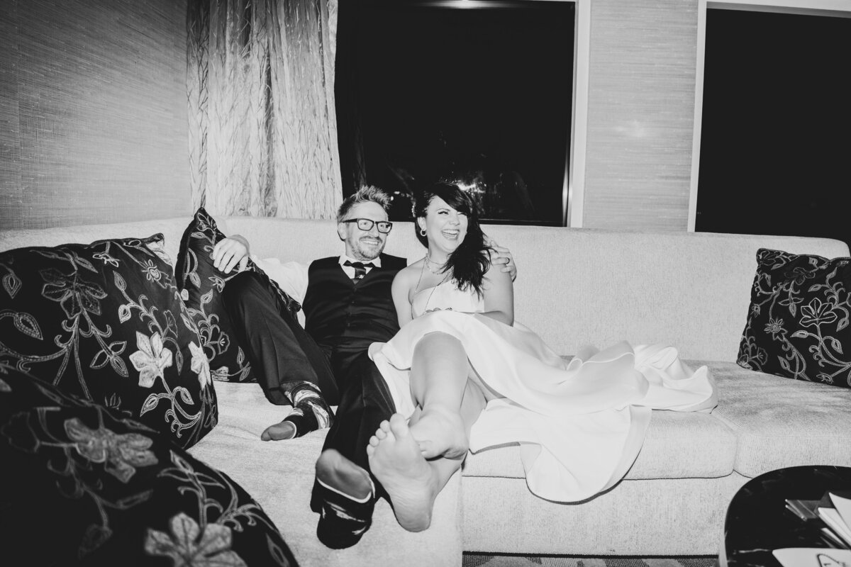 Bride and Groom sit on the couch after reception at the Bellagio in Las Vegas.