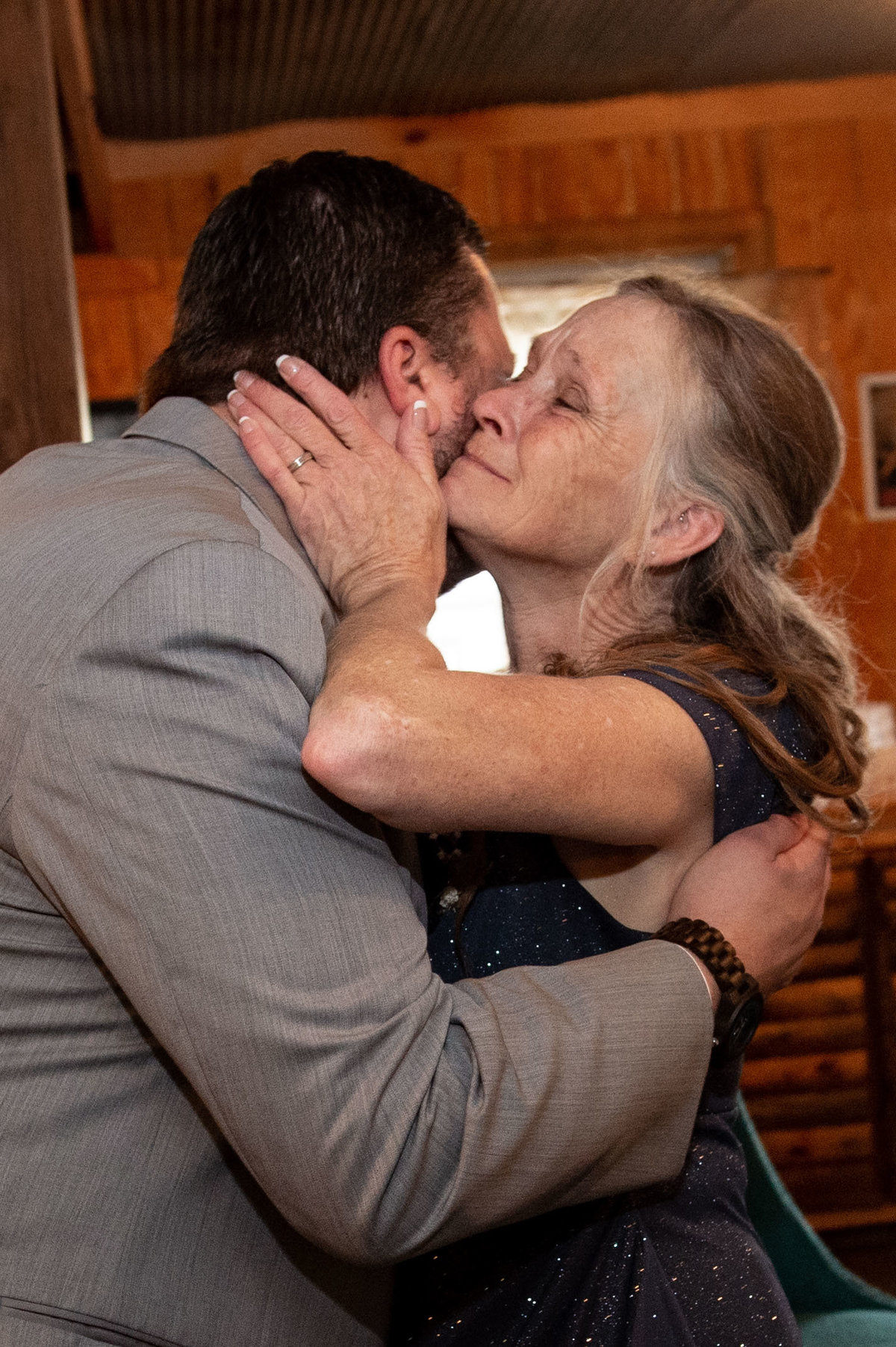 mother kisses groom goodbye