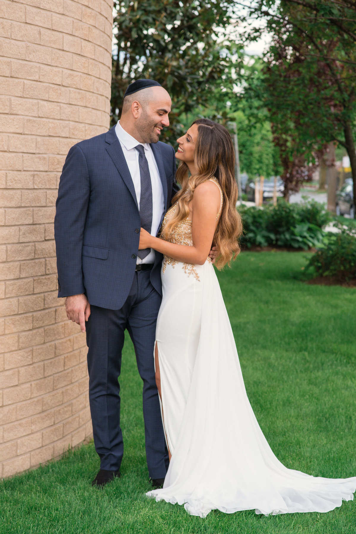 photo of bride and groom outside the Sephardic Temple looking at each other