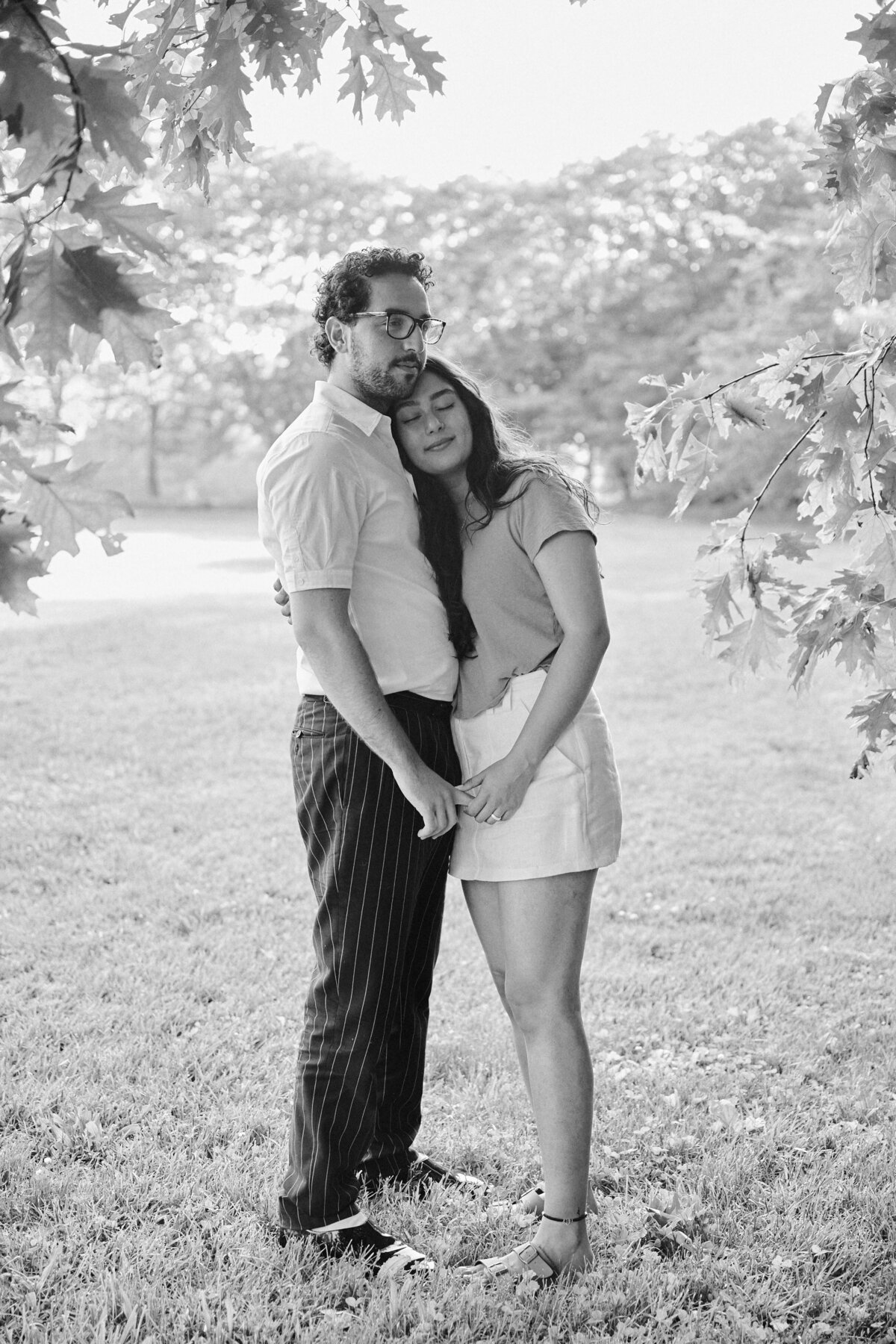 Couple stand face to face smiling after a successful New York City Picnic Proposal.  Photo taken by NYC Proposal Photographer, Corey Lamar Photography