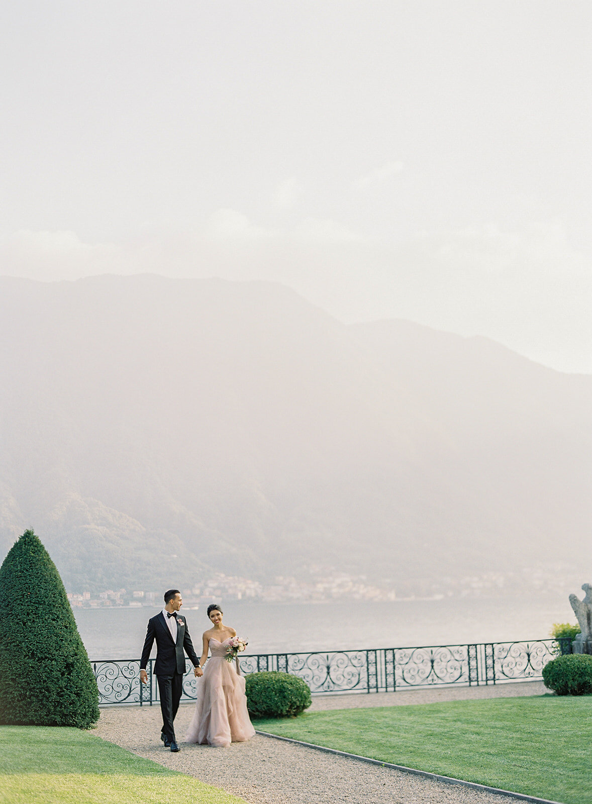 groom and bride stroll at villa balbiano