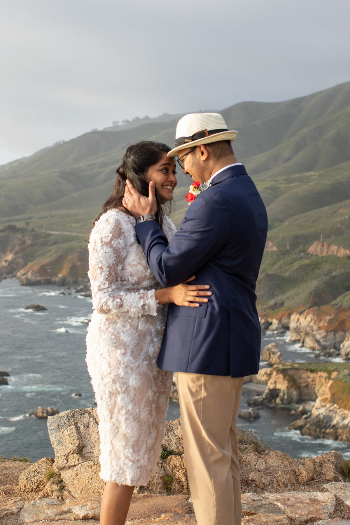 A groom holds his brides face after their elopement ceremony in Big Sur, California.