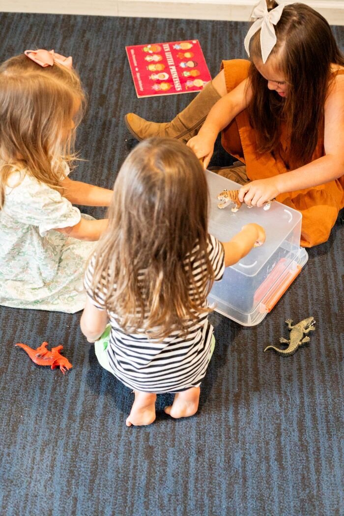 Three students playing in the classroom at The Nest, a preschool and learning center in Surf City, North Carolina