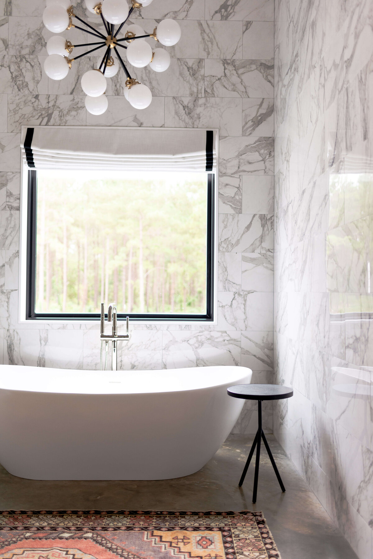 oyster creek studios building belt new build marble walled bathroom with free standing bathtub and accent lighting in bathroom