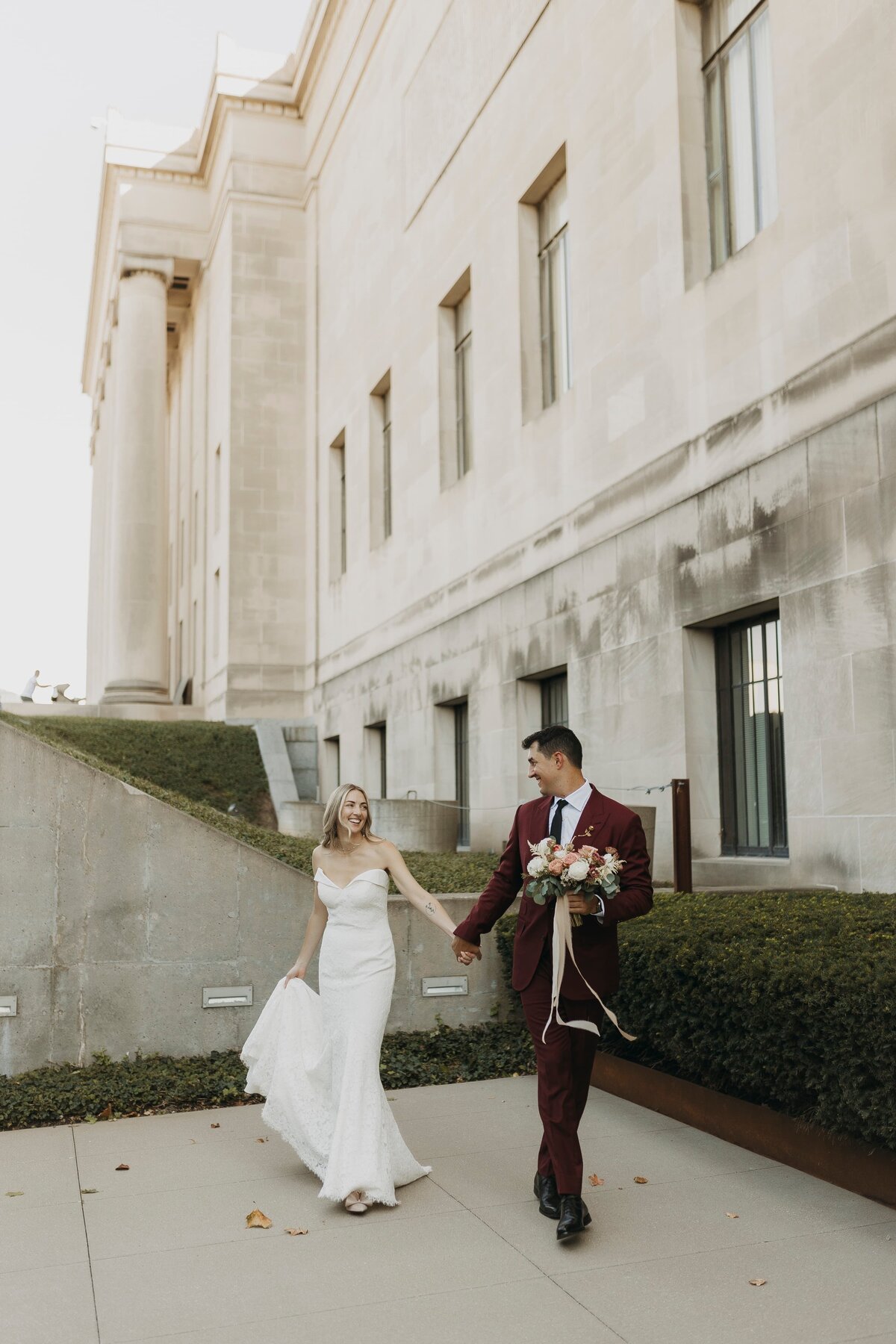 bride and groom walking hand in hand