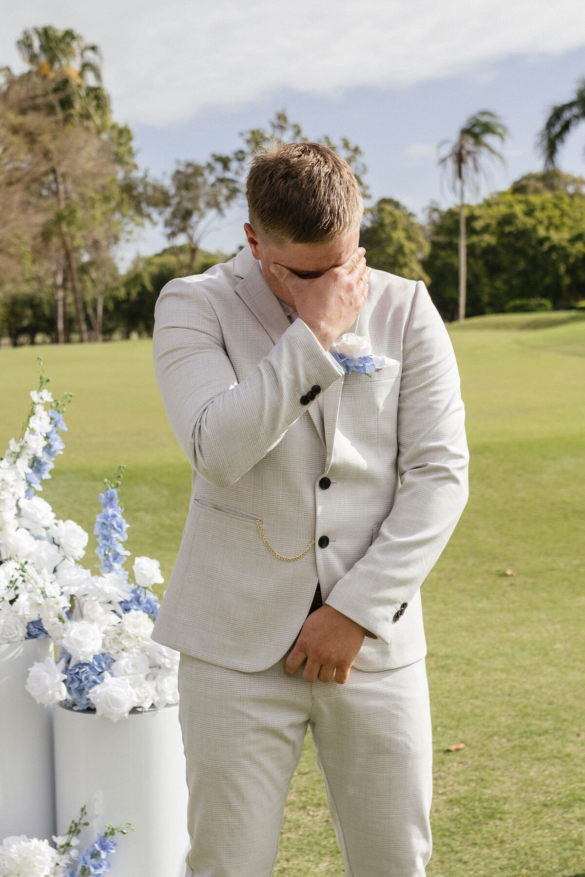 The emotional groom cries while the bride walks down the aisle. 