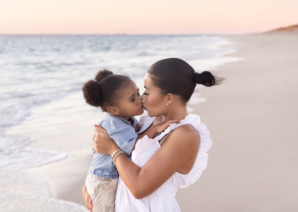 FAMILY_MOTHERANDSONKISSATBEACHSUNSET