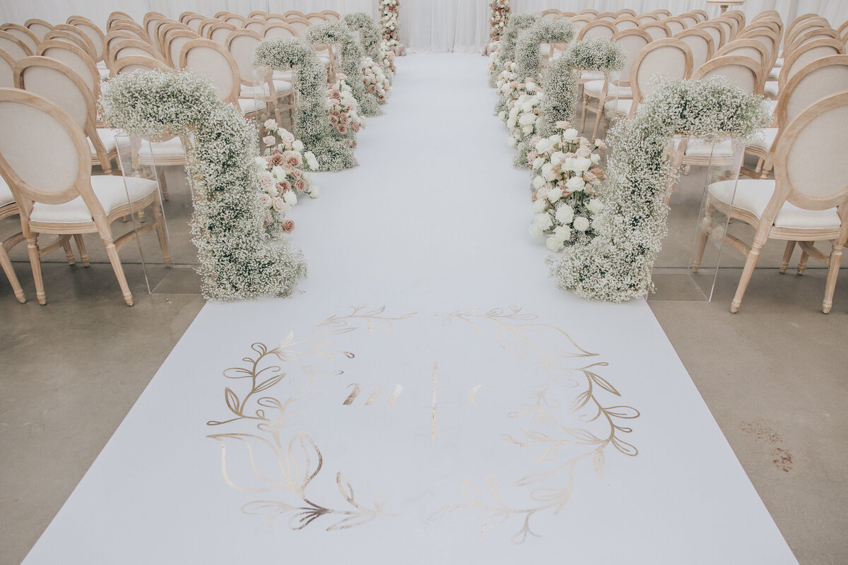 Glamorous ivory and lavender themed wedding featuring aisle filled with roses and baby's breath