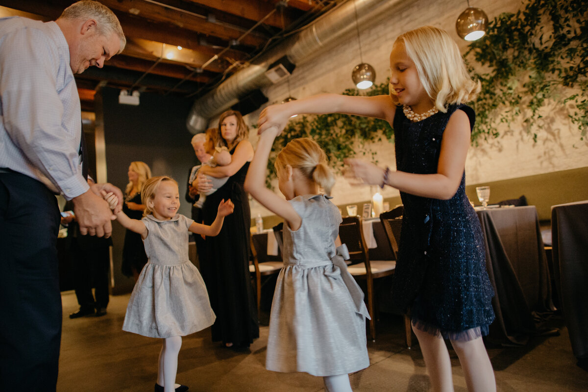 Twin girls enjoying dancing at intimate Chicago wedding