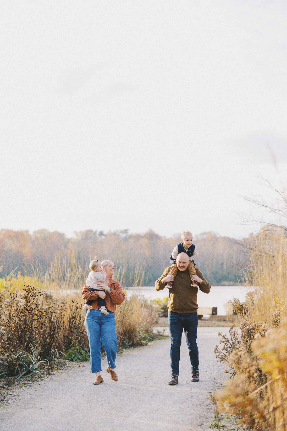 family walking down gravel path together for family photos