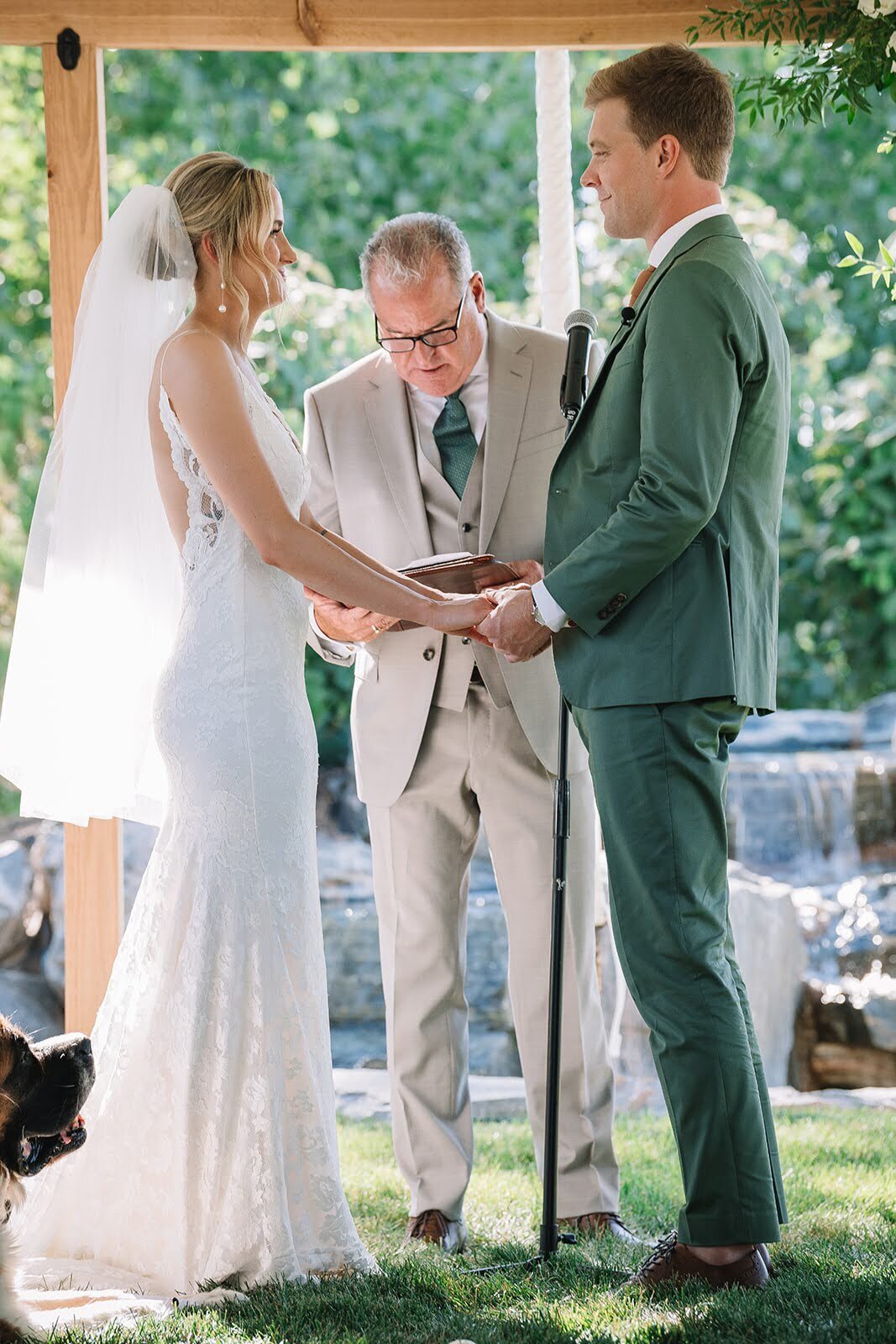 Bride and groom in a green suit during their wedding ceremony in Colorado.