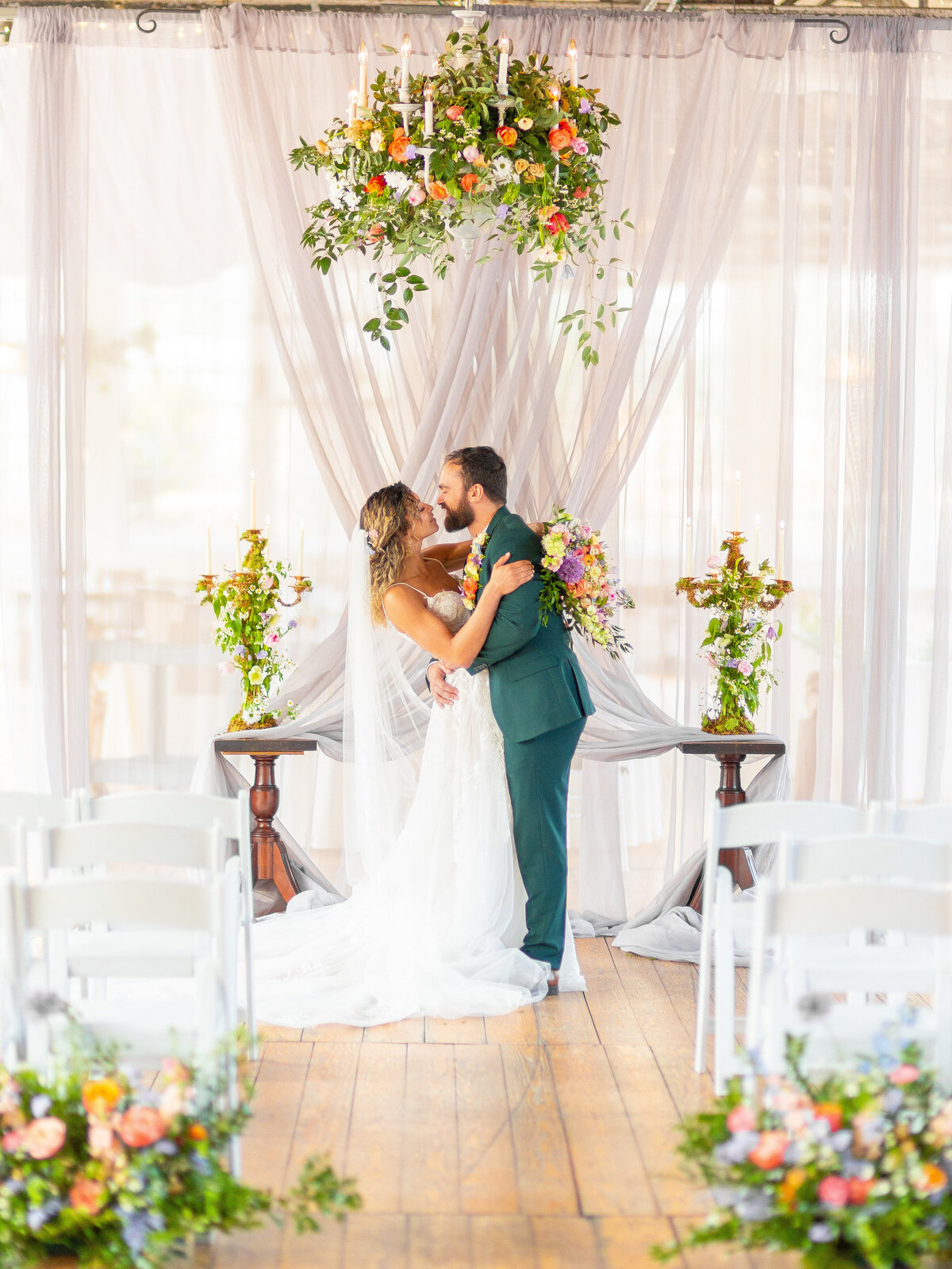 Bride and groom kissing at the wedding alter