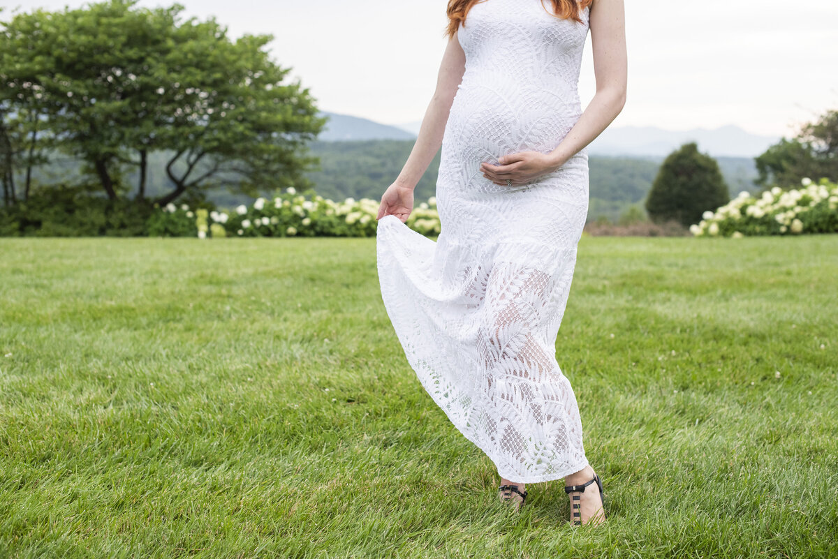 Pregnant woman holding belly maternity photos Asheville NC Biltmore Estate