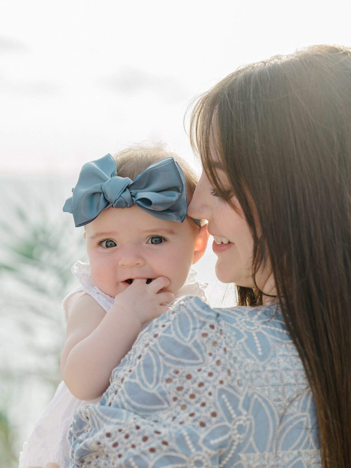Baby girl posing with mom during sunset in Del Mar san Diego