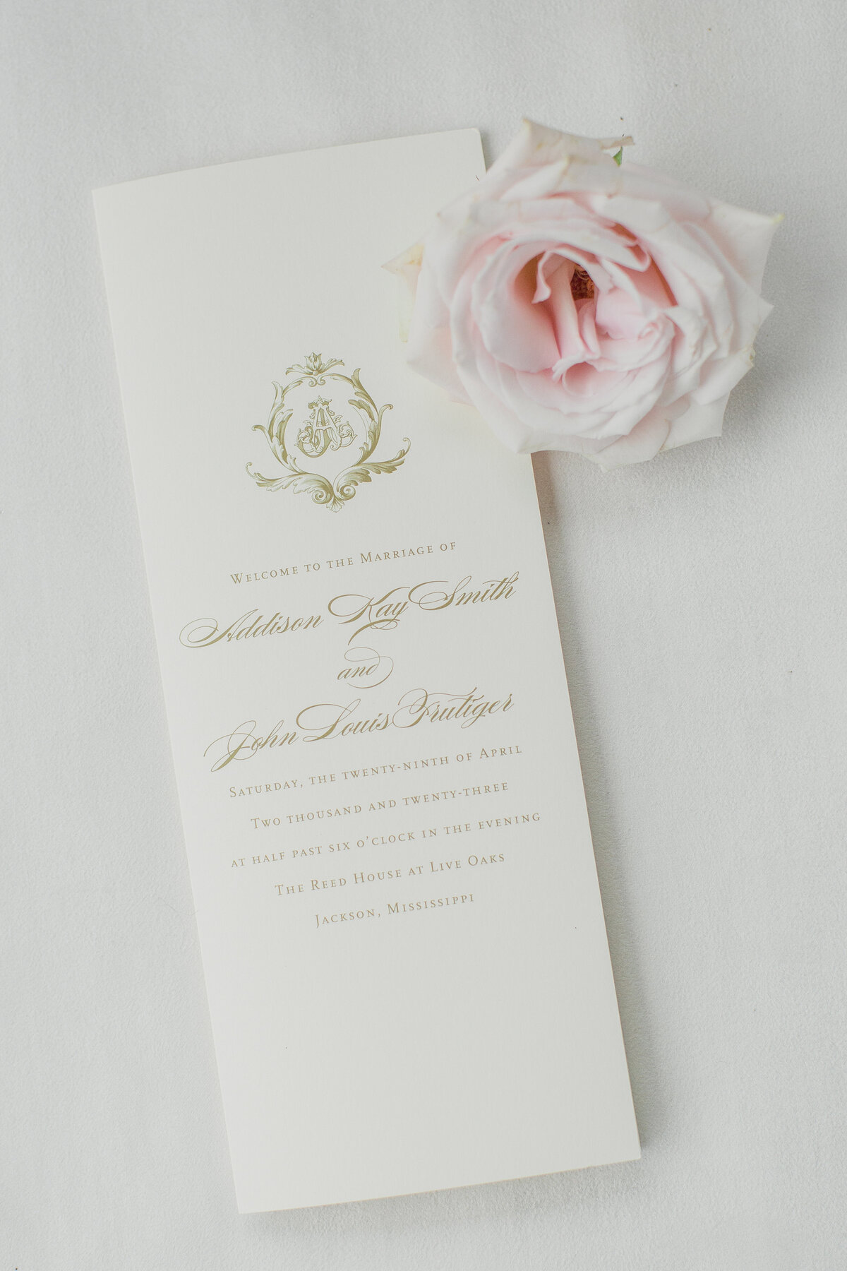 cream wedding invitation with gold text