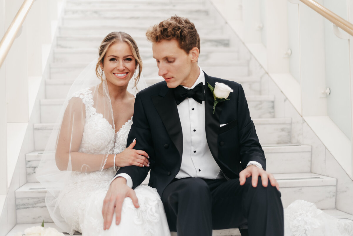 Wedding photography setup by Promani Weddings showcasing a camera, lighting equipment, and beautiful floral arrangements.
