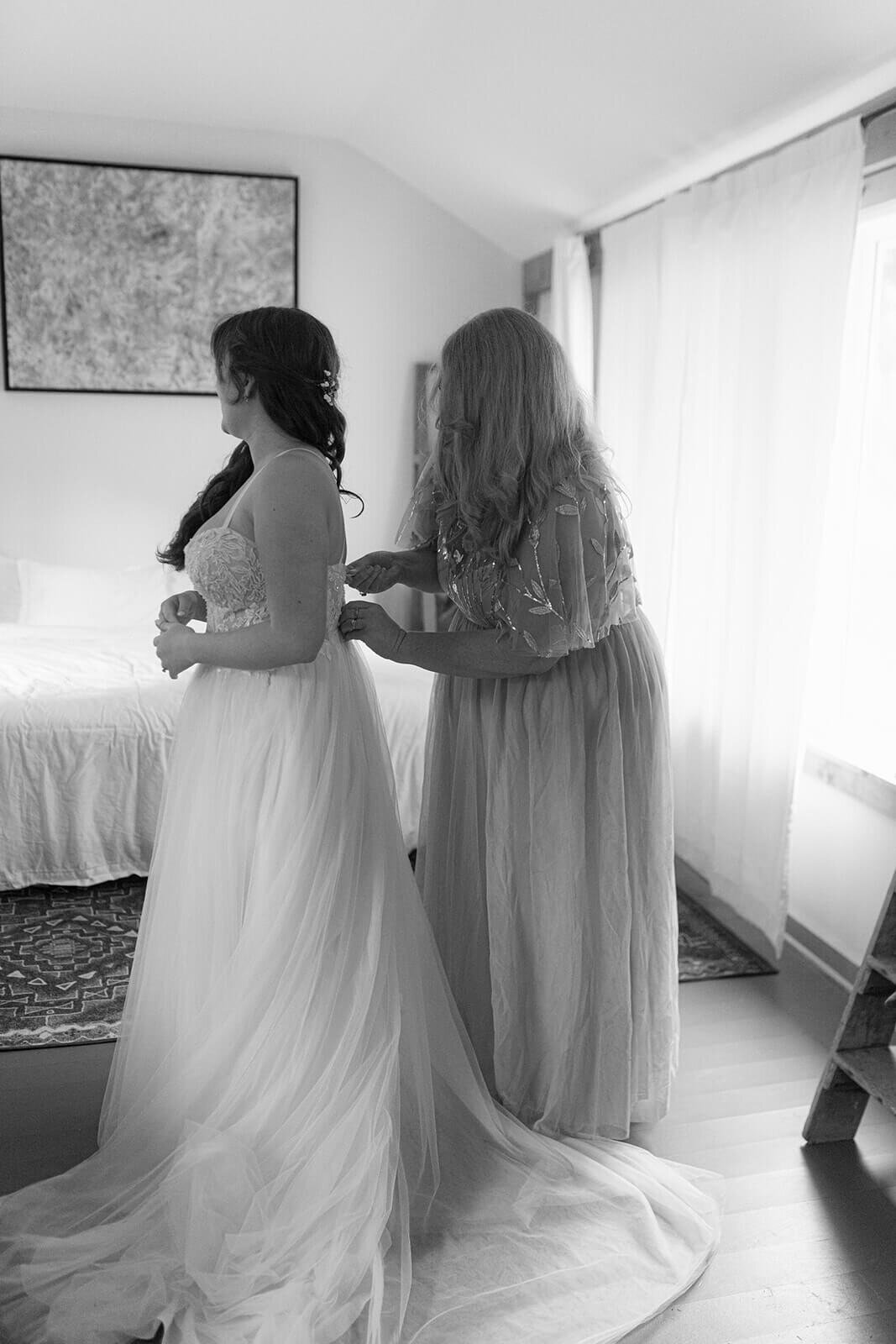 Bride having dress fixed before Finger Lakes wedding, NY