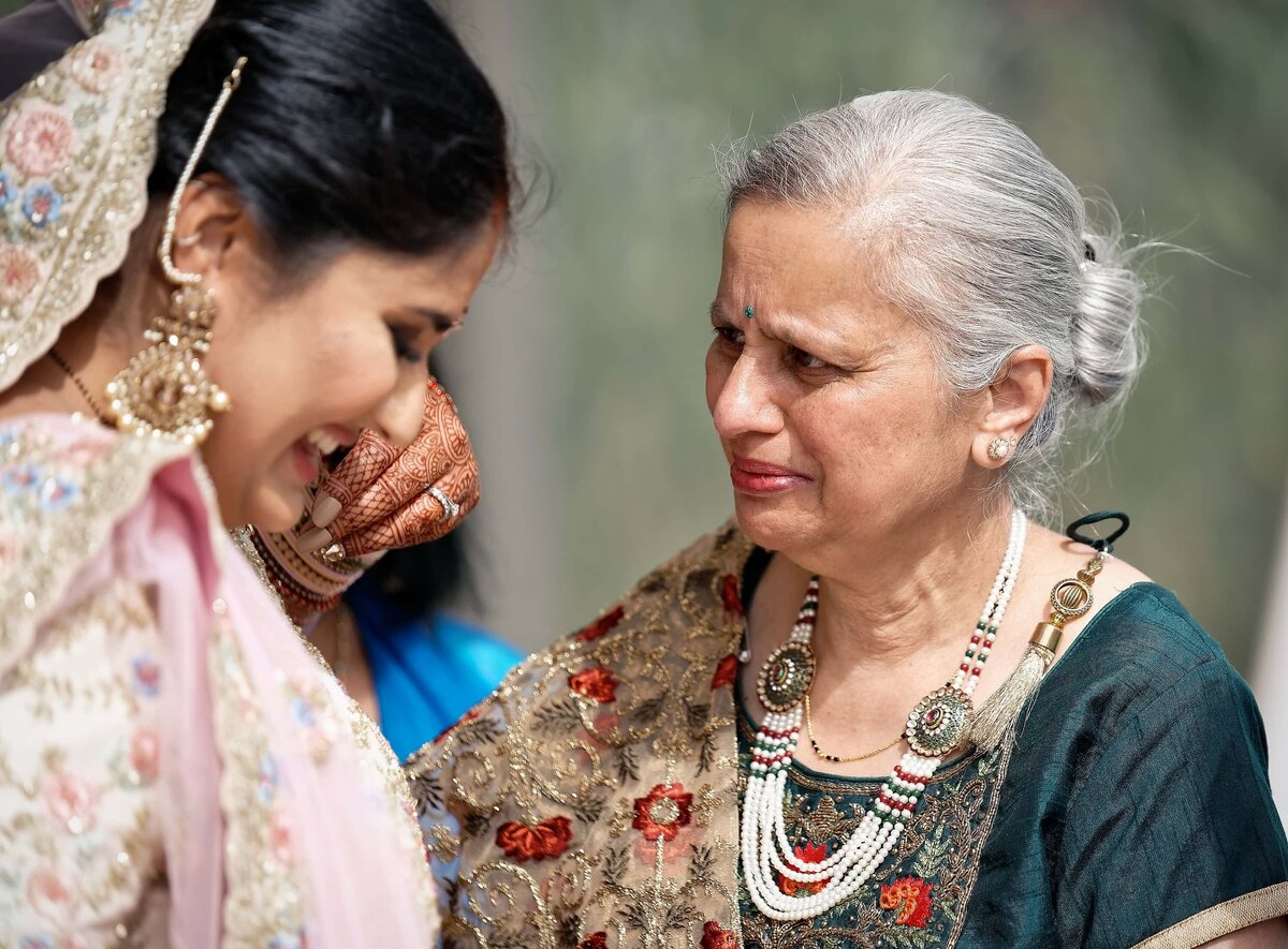 The mother of an Indian bride crying while with her daughter