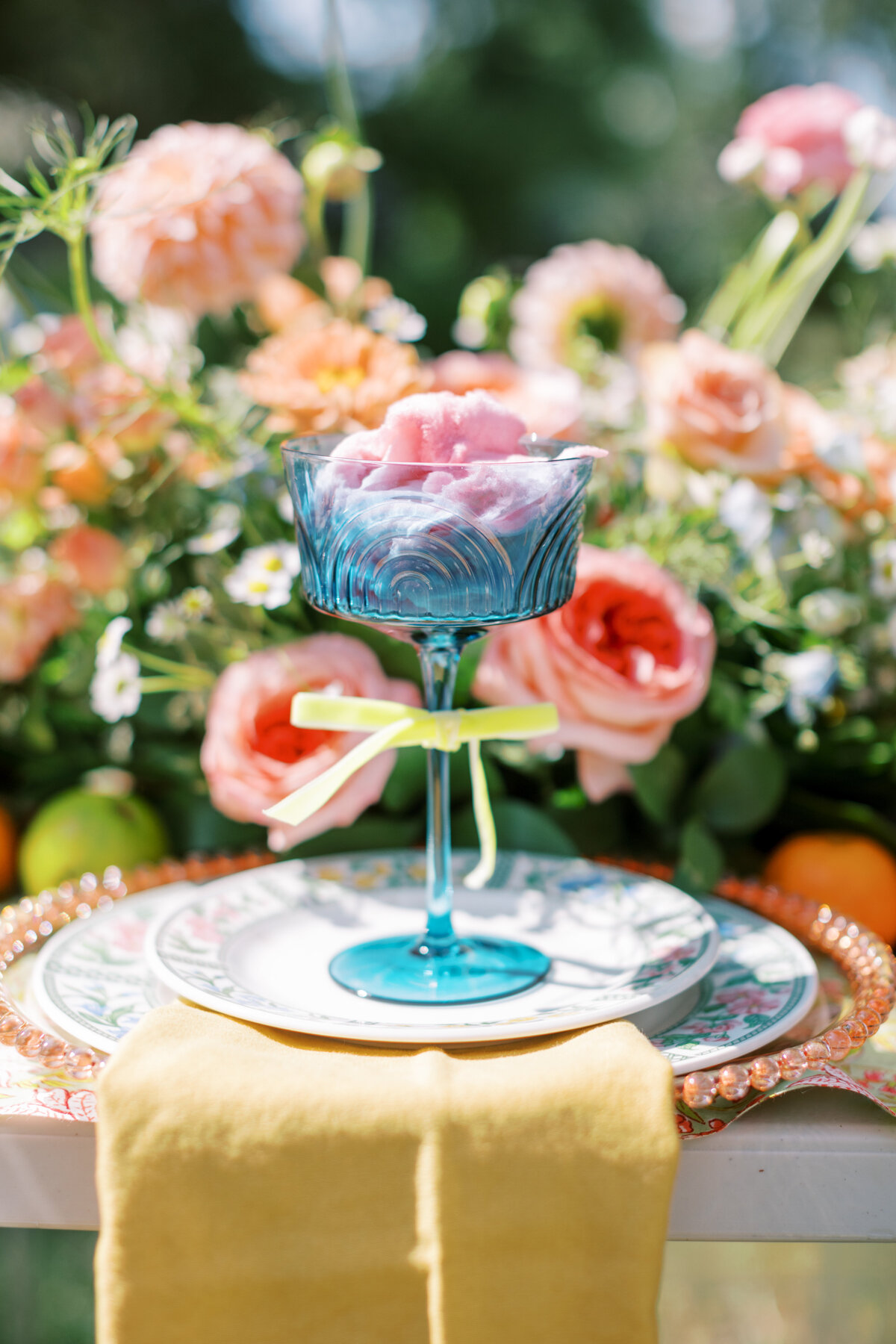 Blue glass and colorful floral arrangements at Alabama wedding reception table
