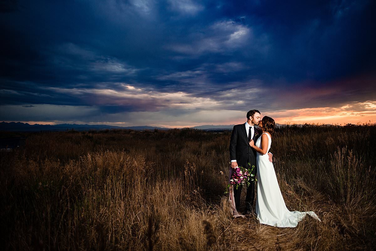 Couple Sharing a Kiss at Sunset in a field in Montana