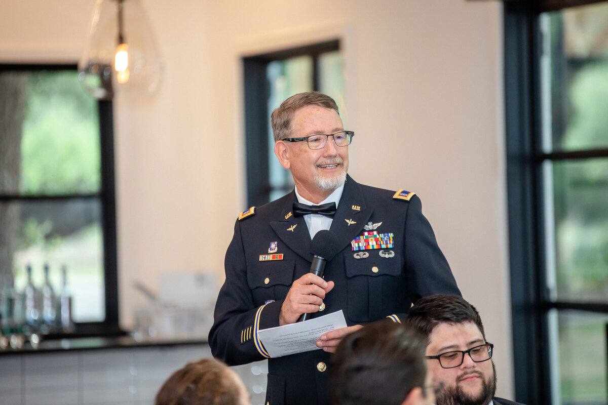 father of the bride in military uniform  gives speech at wedding