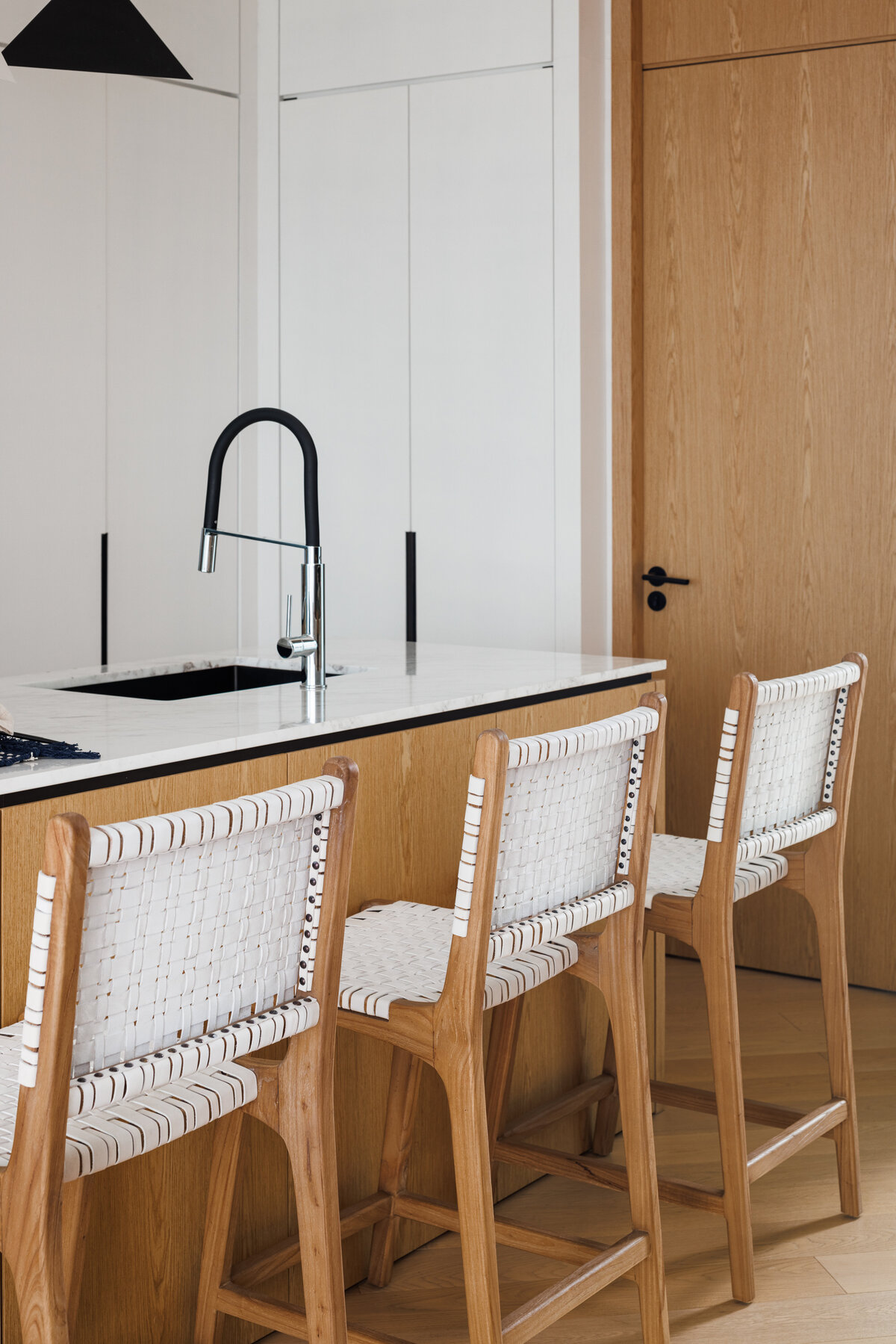 Apartment style kitchen with white  chairs