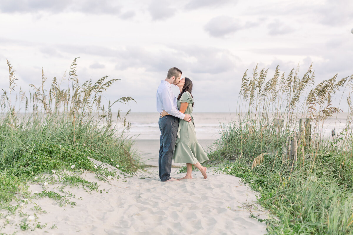 Couple share a kiss on the beach of Kiawah Island in South Carolina.